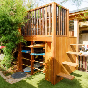 On one wall of the room is board storage with a viewing platform on top with hand carved steps. The oversize bamboo balustrade gives it a tropical look and feel.