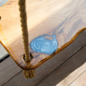 The swing has a beautiful blue swirl resin art seat