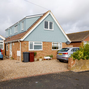 Blue all weather cladding on front of house and new dormers will keep this property energy efficient