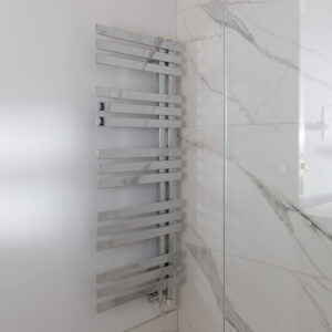 Towel heaters in chrome match the fittings in the entire loft conversion for continuity