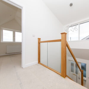 The glass staircase balustrade lets the light flood down to the downstairs hallway