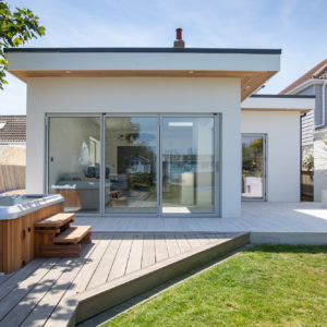 The bi-fold doors closed. The light grey frames match in with the seaside colour palette