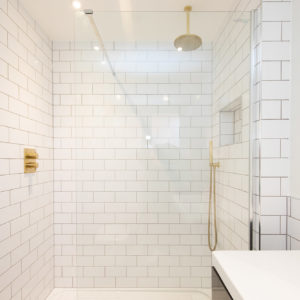 White tiles help enlarge the size of this ensuite